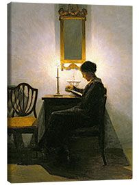 Canvas print Woman reading by candlelight