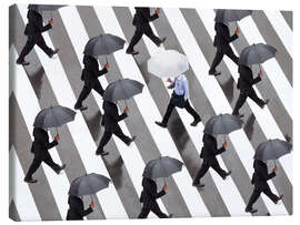 Canvas print Man with umbrella and suit runs as a loner against the tide