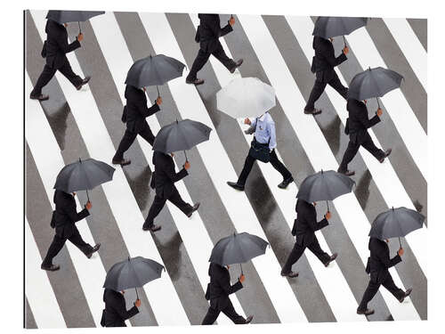 Gallery print Man with umbrella and suit runs as a loner against the tide