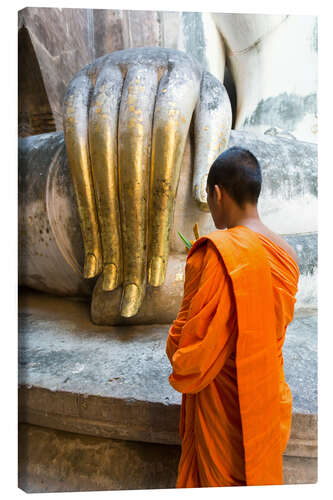 Canvas print Monk praying in front of Buddha Hand