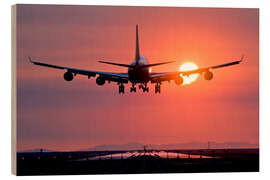 Wood print Aeroplane landing at sunset