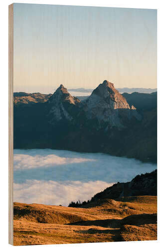 Wood print Grosser and Kleiner Mythen mountain peak above cloudscape at sunrise