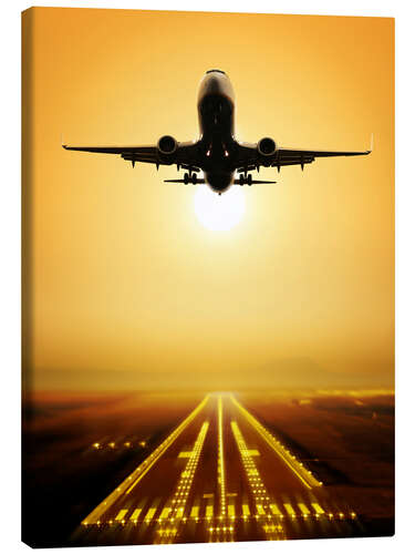 Leinwandbild Start eines Passagierflugzeugs im Sonnenuntergang
