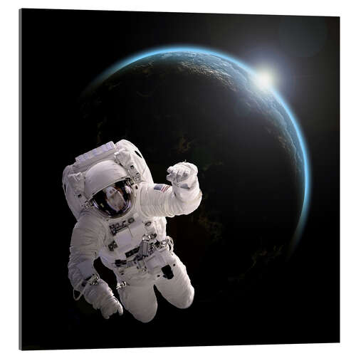 Acrylic print Astronaut floating in space as the sun rises on to Earth-like planet.