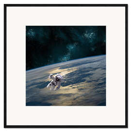 Framed art print An astronaut floating above Earth.