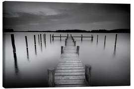 Canvas print Old wooden pier in the still waters