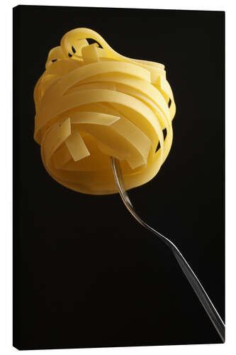 Canvas print Raw tagliatelle on a fork