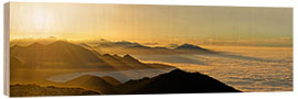 Quadro de madeira Mountain peak over the clouds