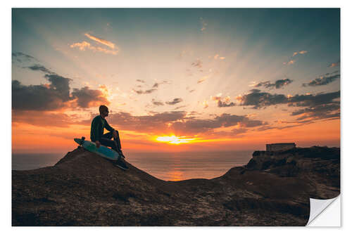 Naklejka na ścianę Young man with skate board watching the sunset