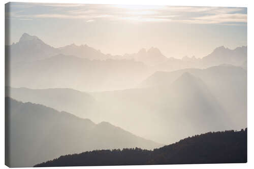 Canvas print Sunlight behind mountain peaks silhouette, the Alps