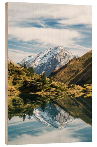 Trebilde Trüebsee mountain lake with Schlossberg mountain peak at Titlis Engelberg in Switzerland at fall