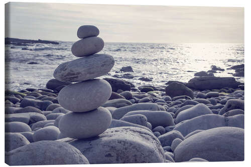 Canvas print Pyramid of pebbles on the sea front