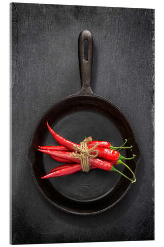 Acrylic print Chili peppers in black iron pan