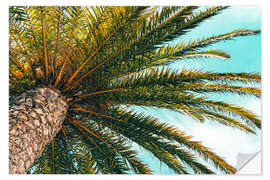 Selvklebende plakat Green palm leaves in front of a blue sky