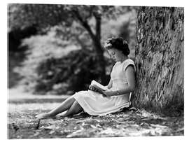 Acrylic print Woman reading under a tree