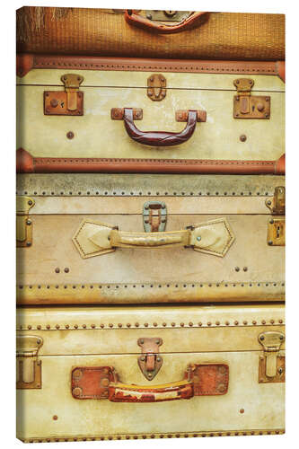 Canvas print Stack of ancient travel suitcases