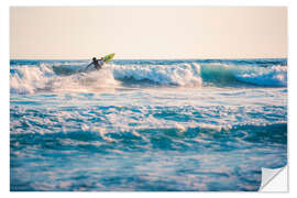 Selvklebende plakat Surfing in the ocean at sunset