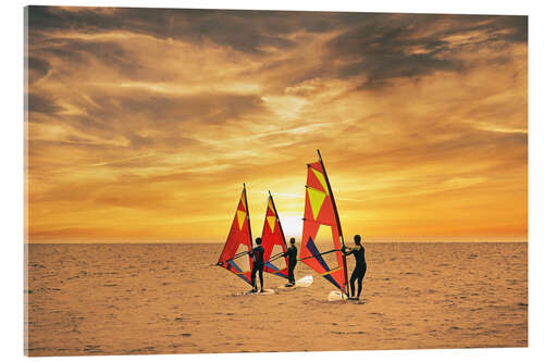 Acrylic print Three surfers in the sunset