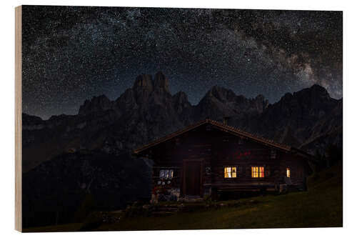 Tableau en bois Illuminated mountain hut with Milky Way in the Alps