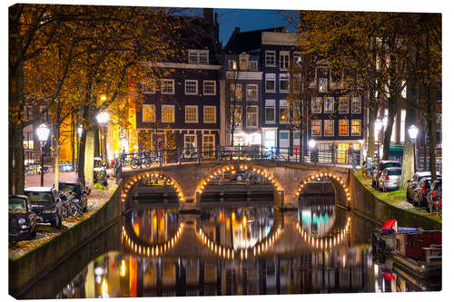 Tableau sur toile Illuminated bridge at night in Amsterdam, the Netherlands