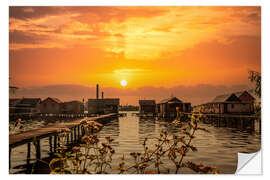 Vinilo para la pared Cottages on the lake with a jetty at sunset