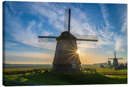 Leinwandbild Sonnenstrahlen und eine holländische Windmühle