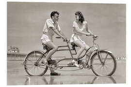 Foam board print Young couple riding a tandem bike on the beach, 1940s