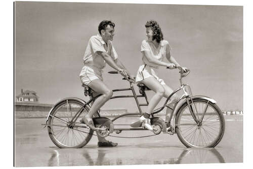 Quadro em plexi-alumínio Young couple riding a tandem bike on the beach, 1940s