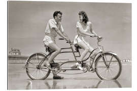 Gallery print Young couple riding a tandem bike on the beach, 1940s