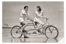 Selvklebende plakat Young couple riding a tandem bike on the beach, 1940s