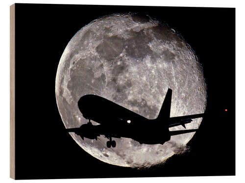Obraz na drewnie Jet silhouetted against the moon