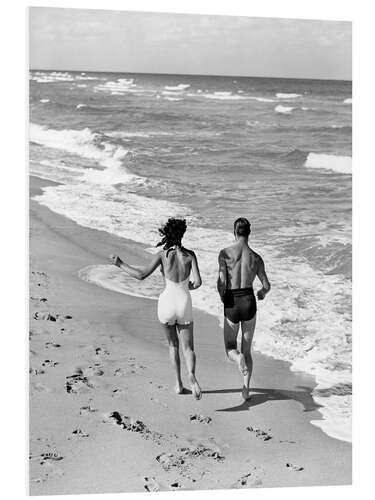 Foam board print Couple wearing jogging at edge of ocean beach, 1930's