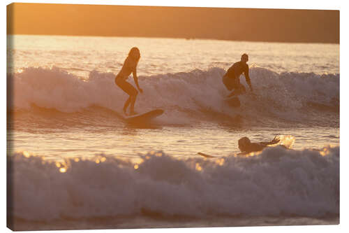Canvas print Surfers backlit in Weligama Bay, Sri Lanka