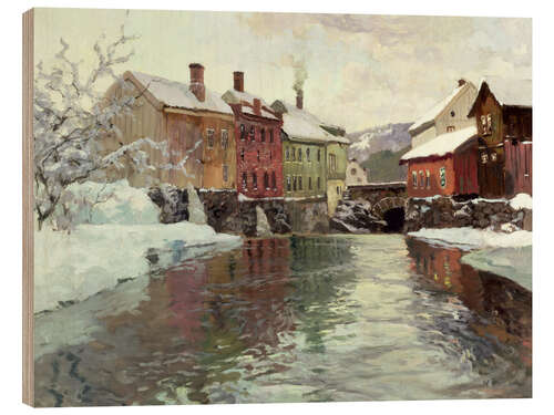 Obraz na drewnie Snow-covered buildings by a river