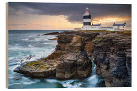 Print på træ Rocky coast with Hook Head lighthouse, Ireland - Moqui, Daniela Beyer