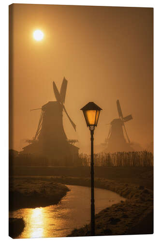 Canvas print Light at Dutch windmills at sunrise