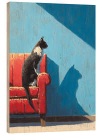 Holzbild Katze sitzt auf einem roten Sofa