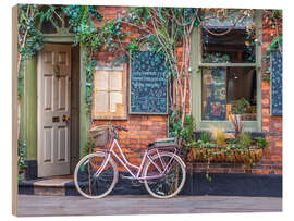 Holzbild Gemütliches Café mit rosa Fahrrad - Assaf Frank