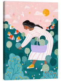 Leinwandbild Eine Frau beim Obstpflücken